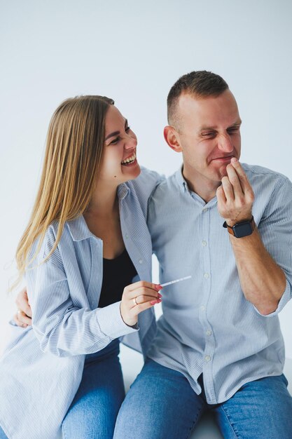 Young happy couple man and woman received a positive pregnancy test and are rejoicing Pregnancy Test