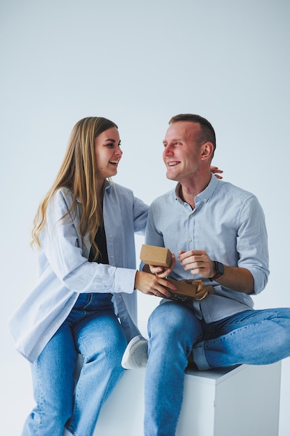 Young happy couple man and woman rejoice and hug Young family smiling on a white background