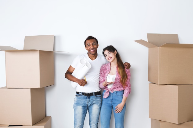 Young happy couple in a new house. Think out the interior. Moving.