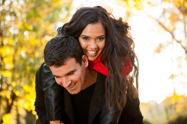 Young happy couple in park having fun