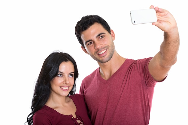 young happy couple smiling while taking selfie