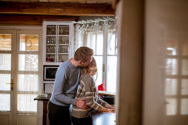 Young happy couple washing dishes