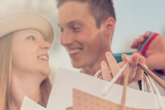 Young happy couple with shopping bags in the city.