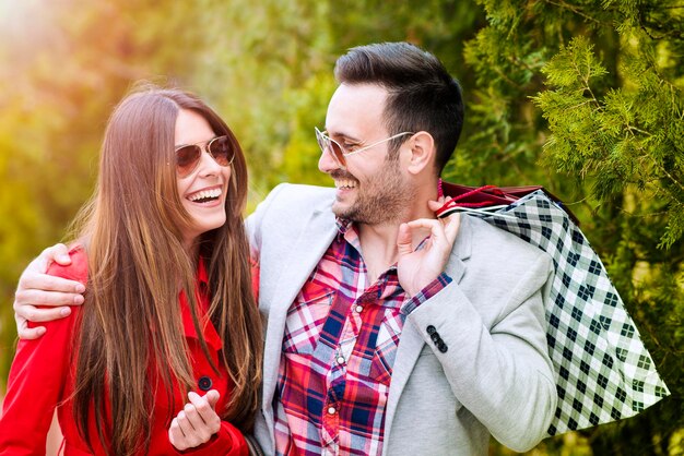 Young happy couple with shopping bags