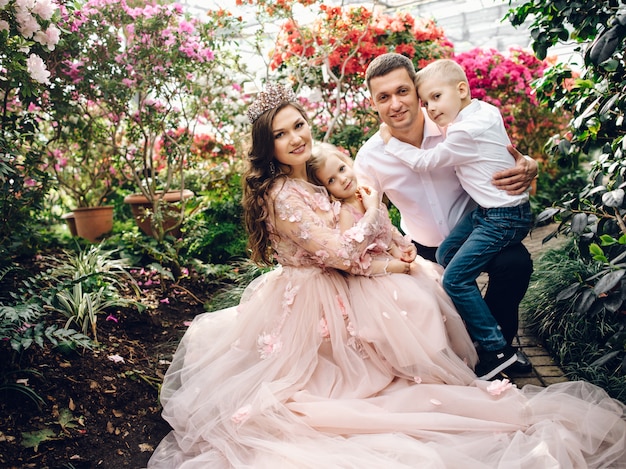 Young happy family in a blooming spring garden