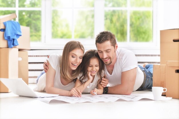 Young happy family moving into their new home