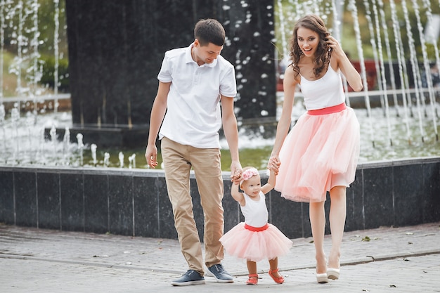 Young happy family near the fountain