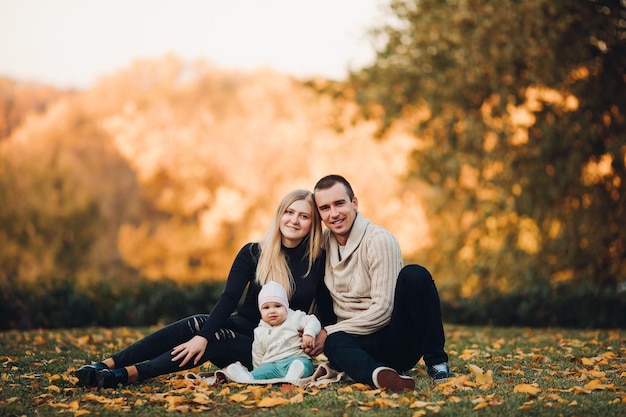 Young happy family smiling at camera and standing together