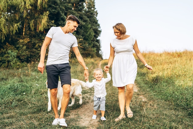 Young happy family with dog have fun outdoor