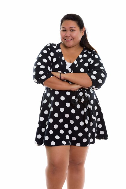 young happy fat Asian woman smiling with dress