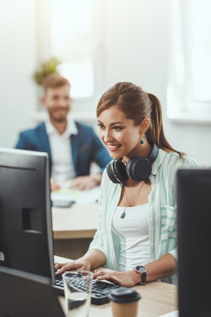 Young happy female freelancer working on a new business project in the casual office.