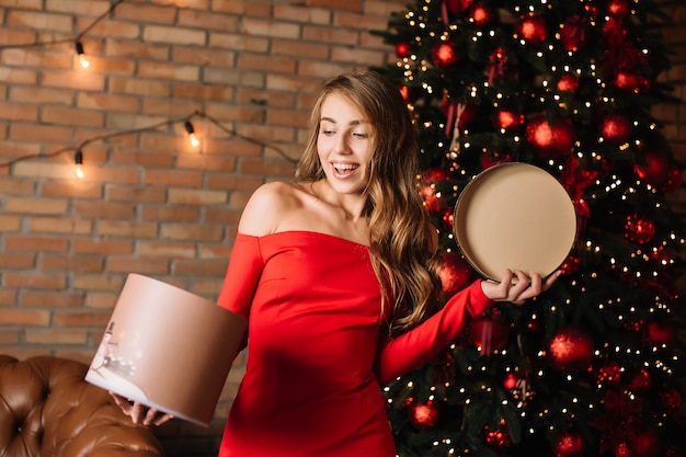 Young happy girl holding gift box in hands.New year present, winter shopping