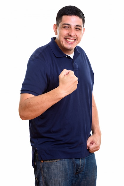 young happy Hispanic man smiling while looking motivated