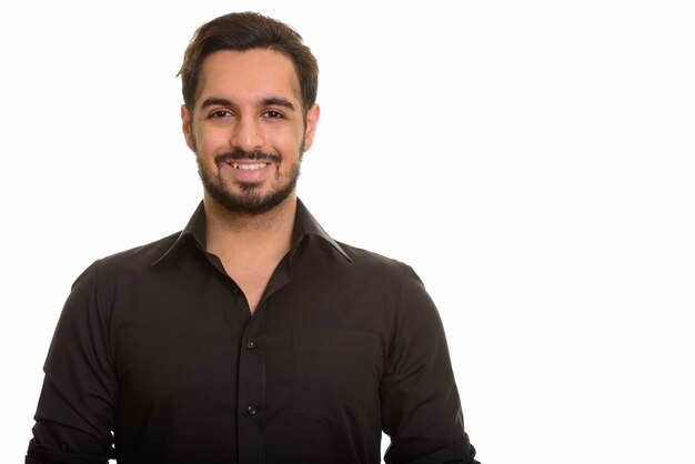 Young happy Indian man smiling and looking at camera