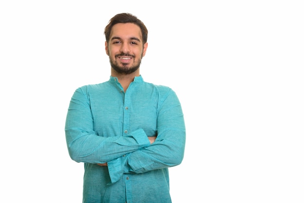 Young happy Indian man smiling with arms crossed