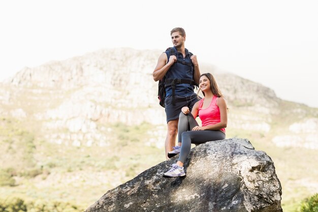 Young happy joggers standing on rock