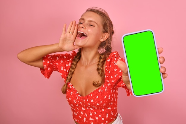 Young happy loud caucasian woman teenager holding phone and shouting