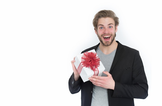 Young happy man in fashion jacket with present box in ribbon isolated on white background business and marketing shopping and black friday valentines day copy space