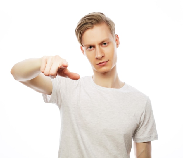 Young happy man with good idea sign in casuals looking at camera isolated on white background.