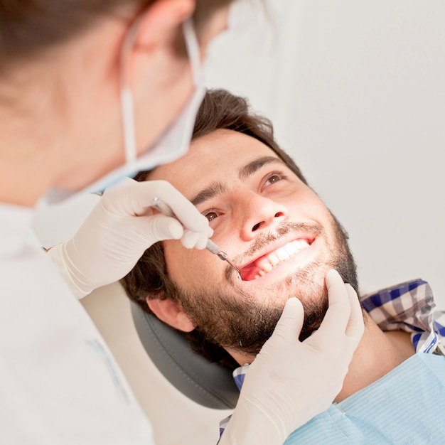 Young happy man and woman in a dental examination at dentist