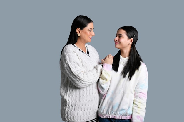 young happy mother standing with daughter indian pakistani model