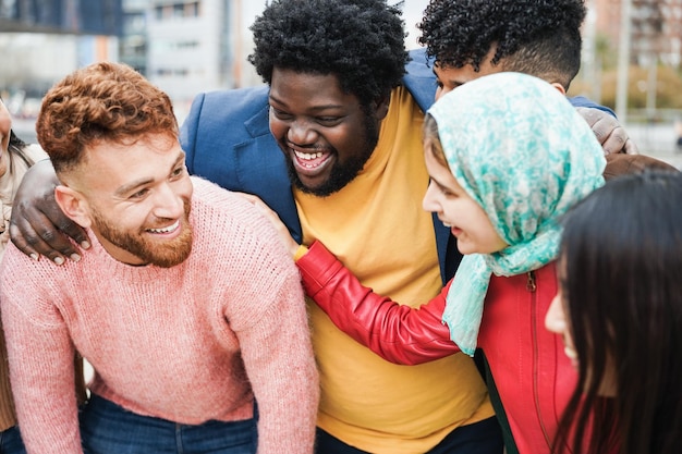 Young happy people having fun outdoor together Focus on african curvy man face