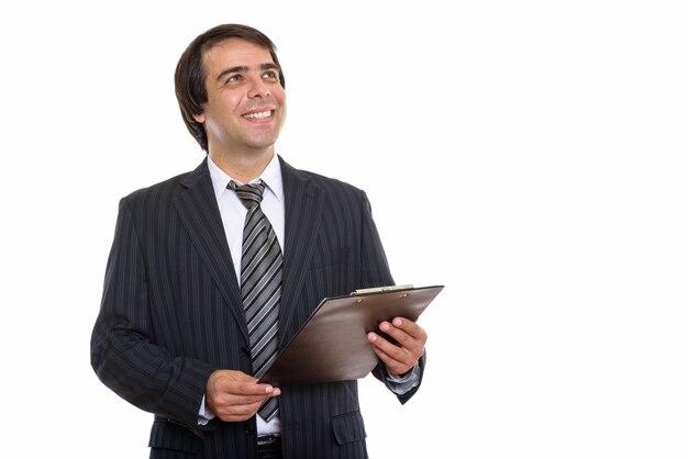 young happy Persian businessman smiling and holding clipboard