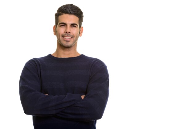 Young happy Persian man smiling with arms crossed