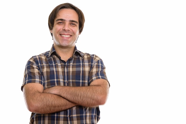 young happy Persian man smiling with arms crossed