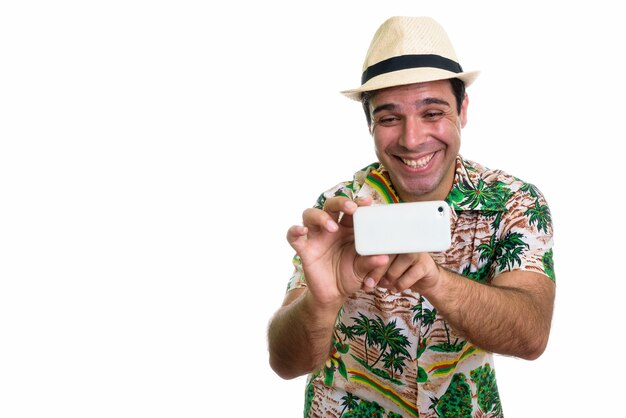 young happy Persian tourist man smiling