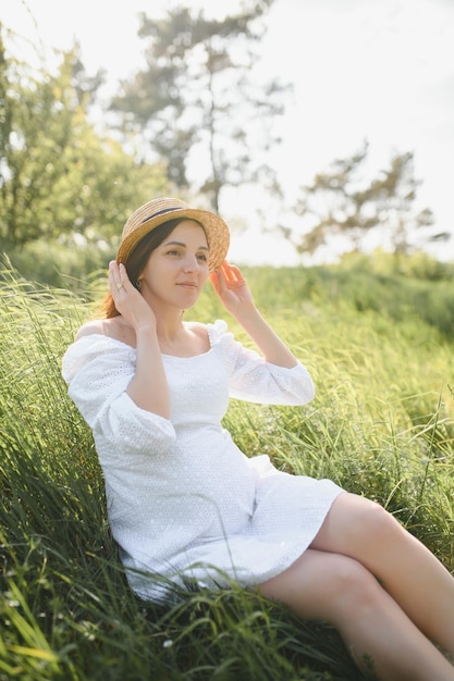 Young happy pregnant woman relaxing and enjoying life in nature Outdoor shot Copyspace