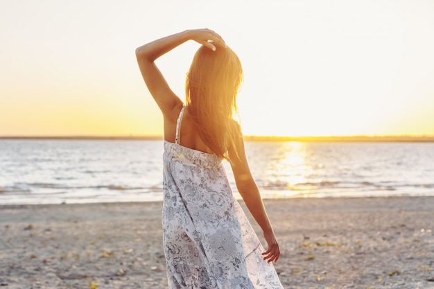 Young happy sexy woman  relaxing on beach. Vacation concept. Mental health, resting