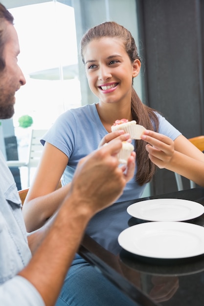 Young happy smiling couple eating cake 