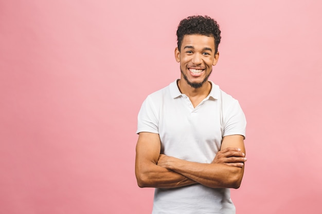 A young happy smiling funny African American male isolated against pink background.