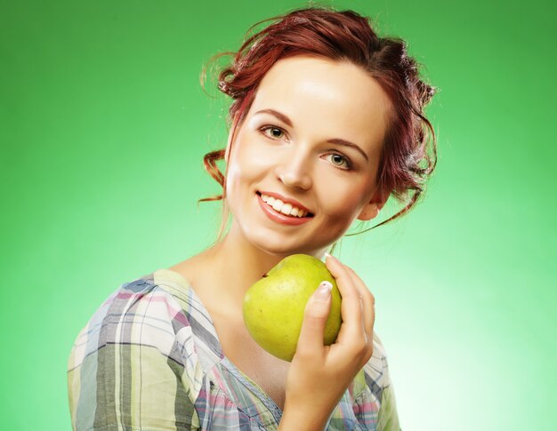 Young happy smiling woman with green apple