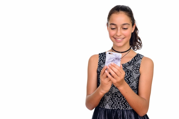 young happy teenage girl using mobile phone isolated against white space