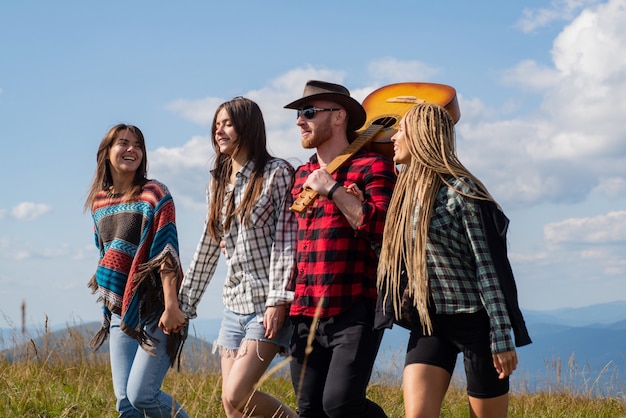 Young happy tourist on mountain enjoying happy young friends enjoy a nice day in nature group of fri...