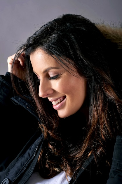 A young happy woman in a black coat