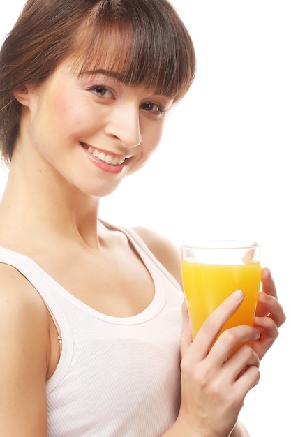 Young happy woman drinking orange juice.