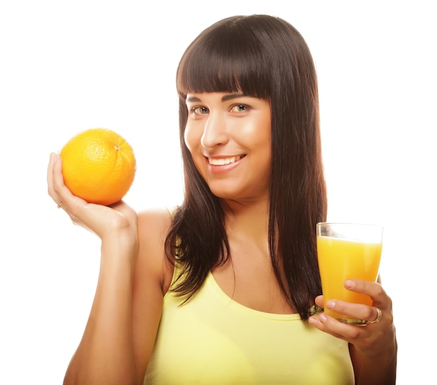 Young happy woman drinking orange juice