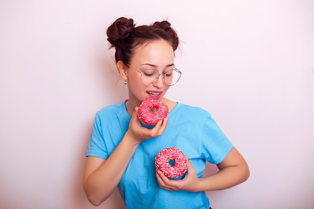 Young happy woman holding donuts