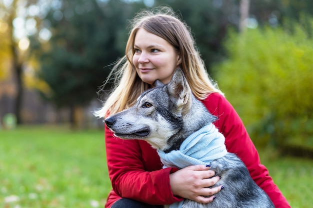 犬を抱き締める若い幸せな女性