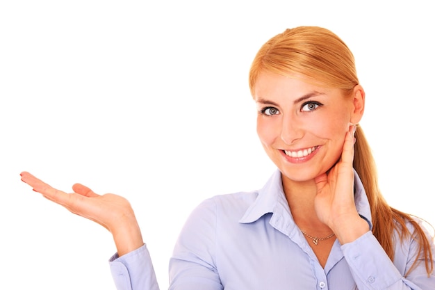 a young happy woman pointing at something over white background