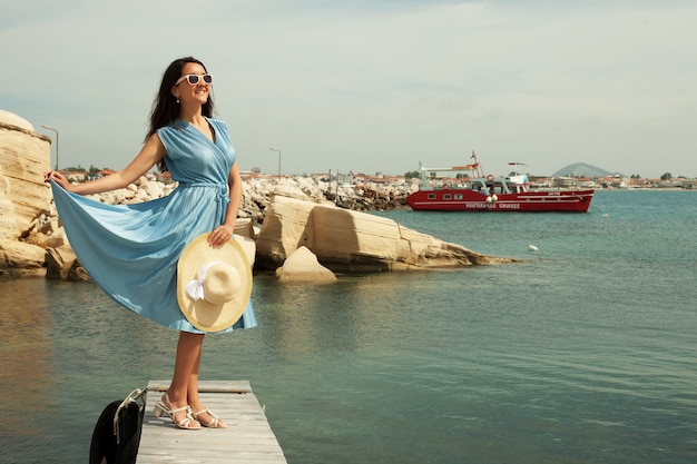 Young happy woman posing near sea