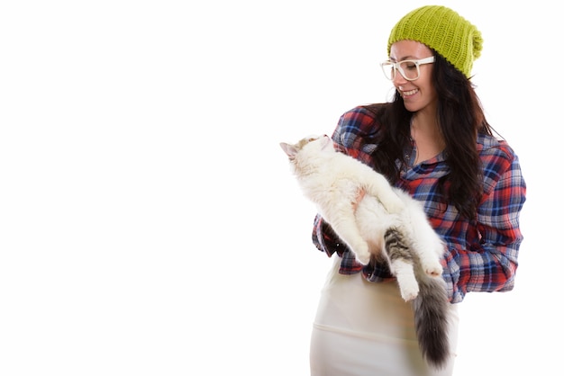 young happy woman smiling while holding and looking a cat