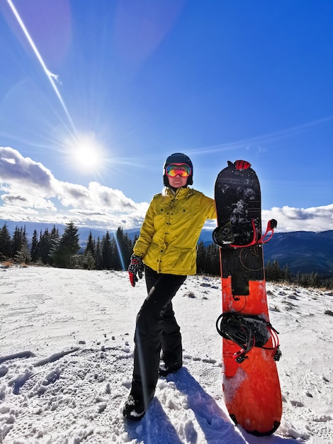 Young happy woman in snowy mountains. Winter sport vacation. 