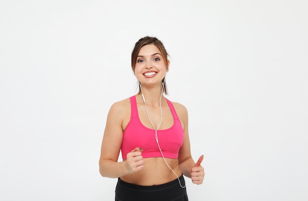 Young happy woman in sportswear posing on a white background sport concept