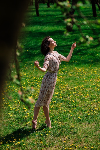 Young happy woman standing on grass