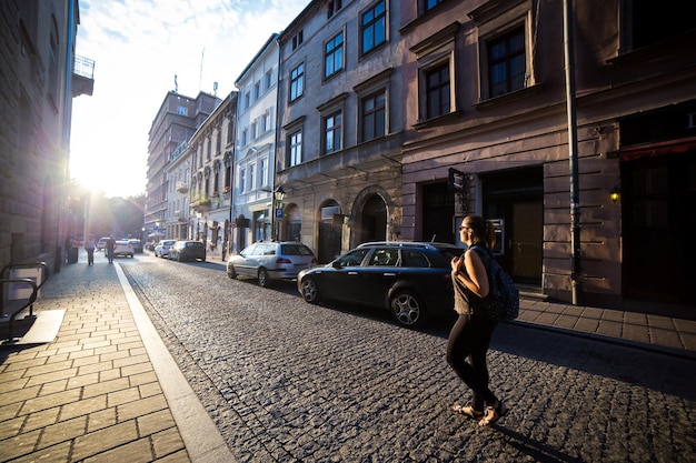 Young and happy woman tourist walking on streets of old european city in Krakow Poland Travels around the Europe