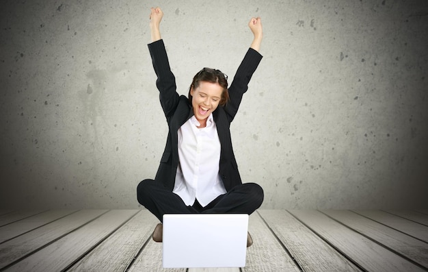 Young happy woman using laptop